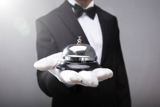 waiter holding service bell - service bell imagens e fotografias de stock