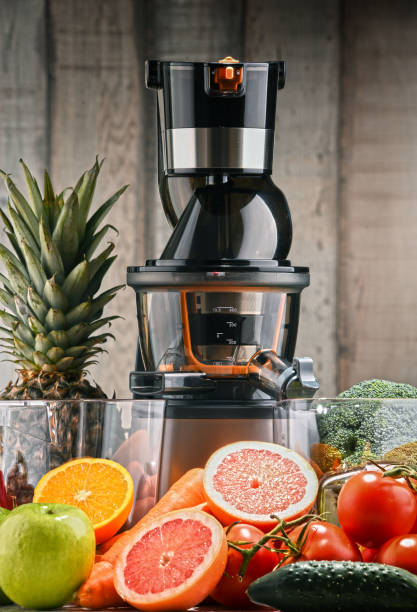 istock Slow juicer with organic fruits and vegetables. 924558682