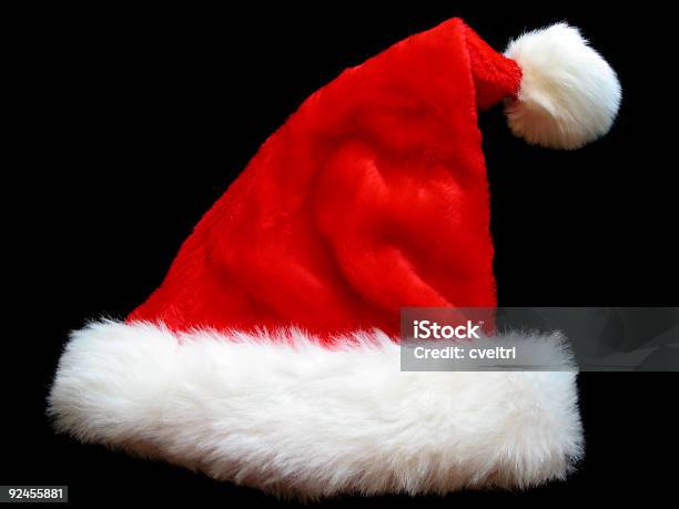 Cappello Di Natale - Fotografie stock e altre immagini di Cappello da Babbo Natale - Cappello da Babbo Natale, Sfondo nero, Abbigliamento