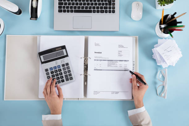 istock Businesswoman Calculating Invoices 924559094