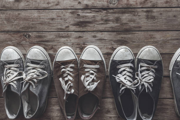 istock Canvas shoes in a row on wooden flooring 924559442