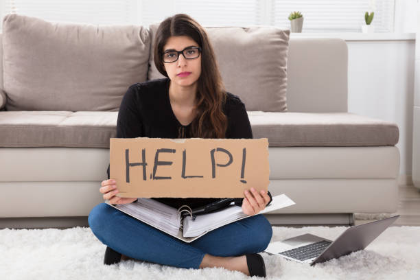 istock Woman With Help Sign While Calculating Bills 924559746