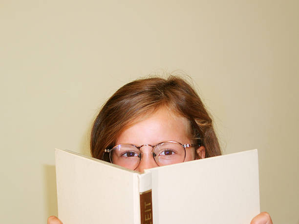 istock Girl behind book_31 92456107