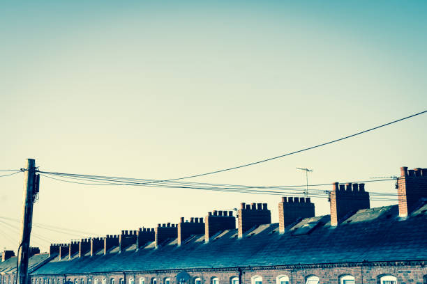 Telephone wires and the roof line of a row of terrace houses stock photo