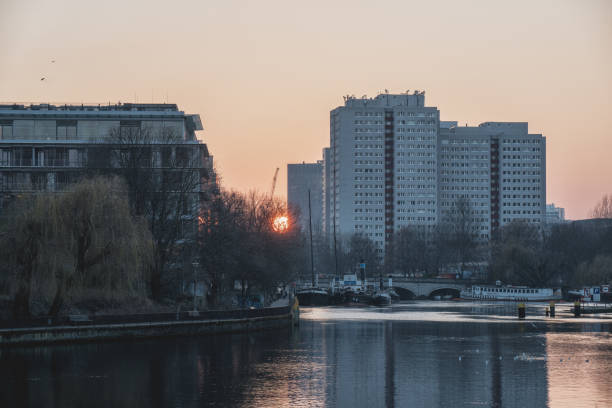 istock sunset by the river and residential buildings 924565736