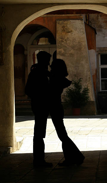 lovers in archway stock photo