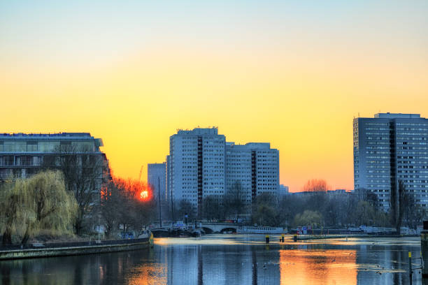 istock sunset by the river and residential buildings 924568116