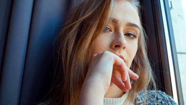 istock Young woman sitting by a window. 924569082