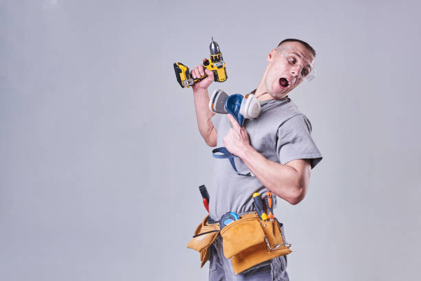 istock Master Builder-finisher in work clothes, with a drill screwdriver in hand 924575304