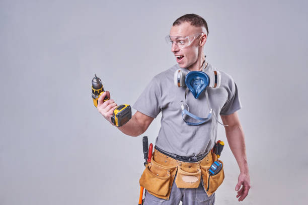 istock Master Builder-finisher in their working clothes, surprised the drill 924575458