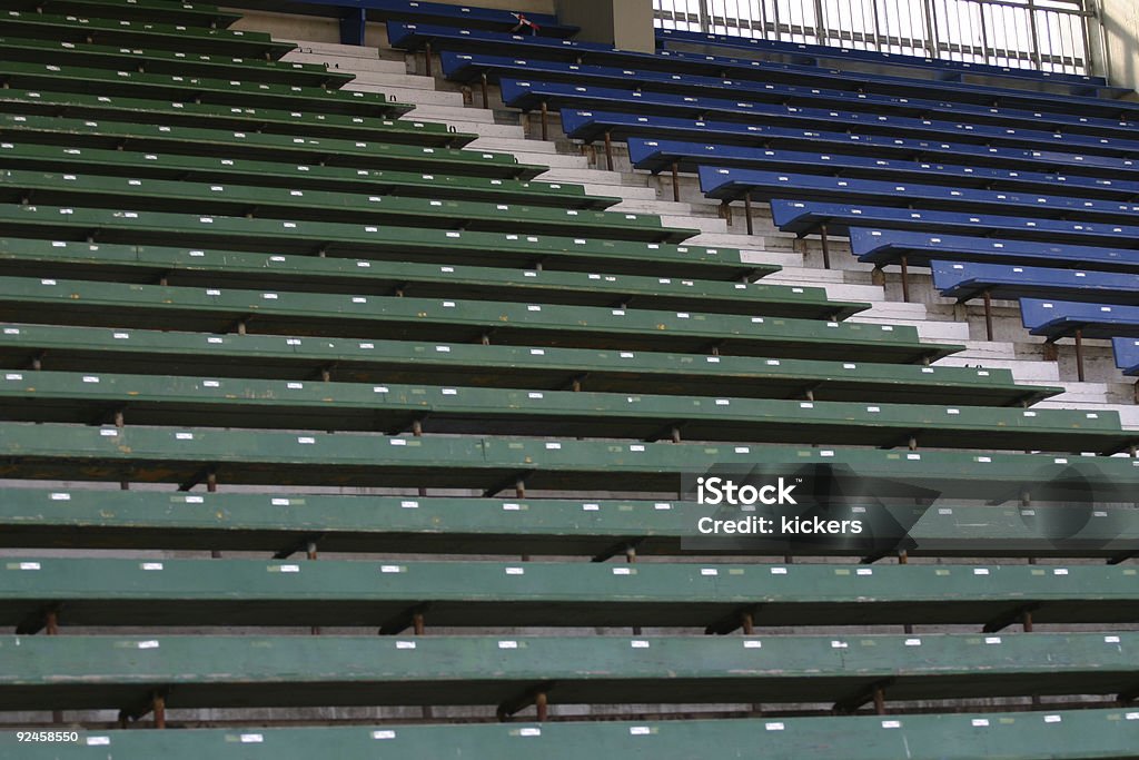 Rows of wooden banks in a soccer stadium, Rows of wooden banks in a soccer stadium, blue and green. Miserly Stock Photo