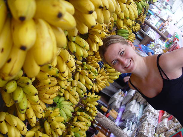 istock Female Sampling Bananas at the Markets 92458976
