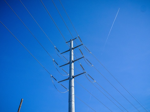 transmission tower with power lines and a blue sky