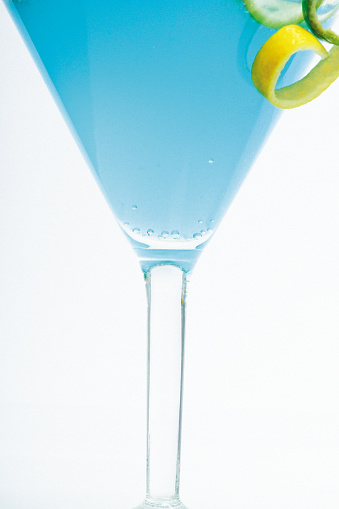 Blu martini with lemon and lime twist close-up