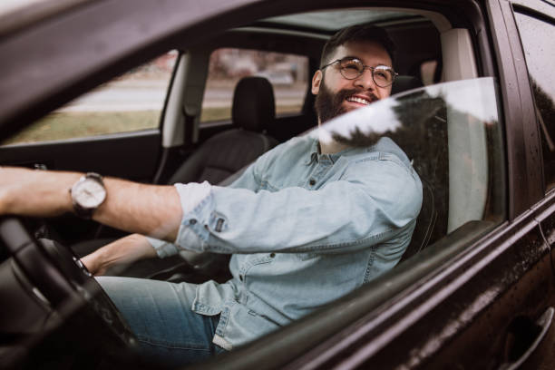 istock Smiling man driving in car 924598538
