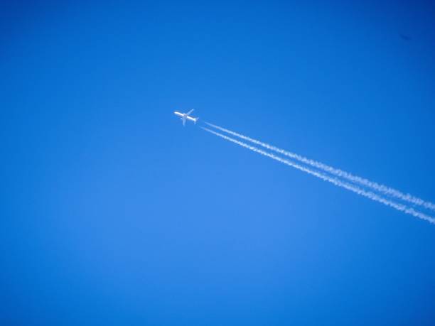 istock airplane and vapor trail 924604260