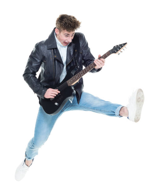 istock Handsome young male playing an electric guitar and jumping 924604864