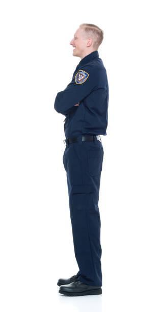 istock Handsome and friendly looking policeman with arms crossed 924609050