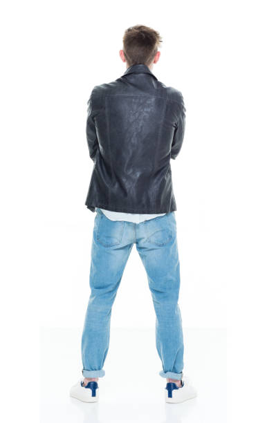 Full body of distrusted male in elegant suit looking away with doubtful face expression isolated on white background in studio