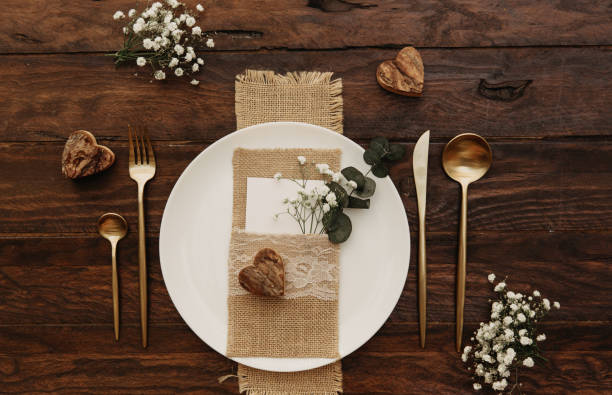 istock Rustic Wedding. Vintage gold cutlery with eucalyptus an old wooden background. 924618004
