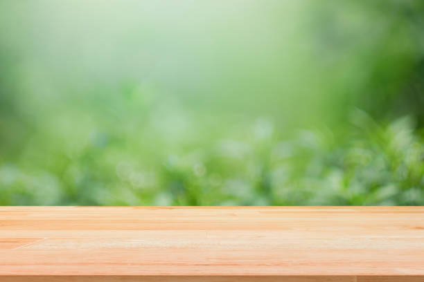 istock Wooden table top on green nature background template display 924618076