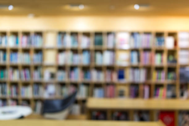 istock Blurred library with many books on bookshelf indoor with lighting on ceiling using as background 924620634