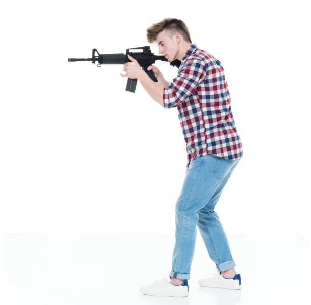 istock Teenager with assault rifle 924621012