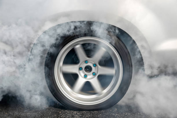 istock Drag racing car burn tire at start line 924621080