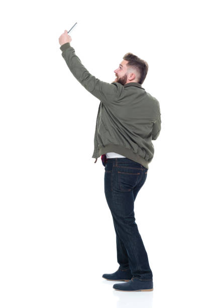istock Cool guy with jacket and red shirt holding coffee and phone 924621396