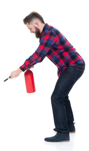 istock Handsome male in plaid shirt with fire extinguisher 924621428