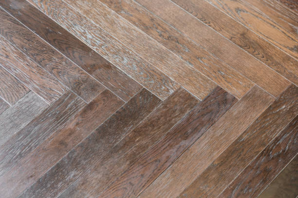 istock zigzag wood floor pattern background with light from window close up detail 924624438