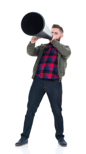 istock Interesting man in casual clothes using megaphone and being silly 924627192