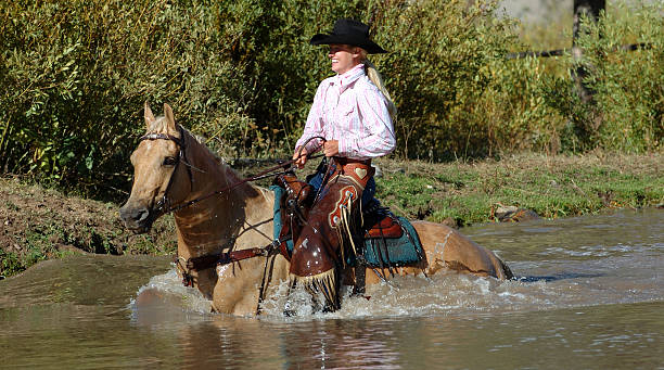 Cowgirl in Pond stock photo