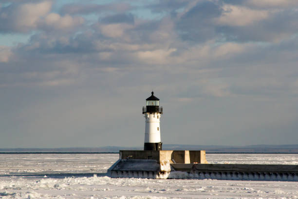 istock Frozen Lake Superior shoreline with lighthouse on pier 924627368