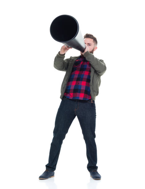 istock Interesting man in casual clothes using megaphone and being silly 924628772