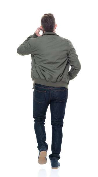 istock Cool guy with jacket and red shirt holding coffee and using smart phone 924628792