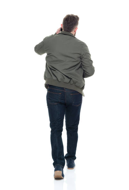 istock Cool guy with jacket and red shirt holding coffee and using smart phone 924628802