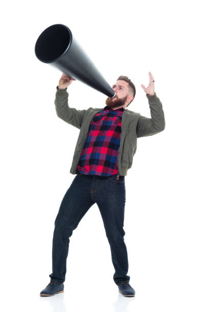 istock Interesting man in casual clothes using megaphone and being silly 924628818