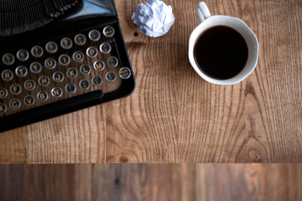 istock Typewriter and a mug of hot coffee on a wooden table 924631994