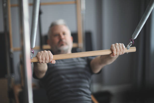 istock Man pilates reformer exercises 924632000