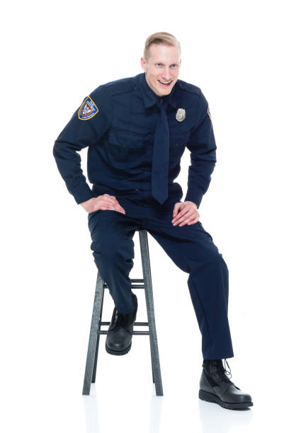 istock Handsome police officer sitting on black stool 924632040