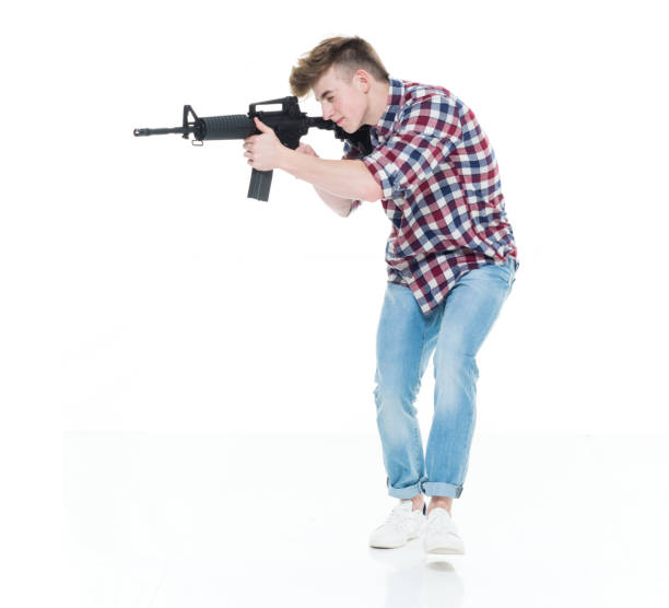 istock Teenager with assault rifle 924632880