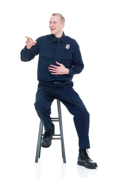 istock Handsome police officer sitting on black stool 924633136