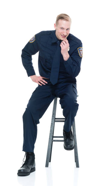 istock Handsome police officer sitting on black stool 924636078