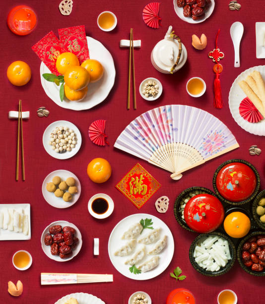Chinese new year food and drink large group of objects on red background. Flat lay Chinese new year decoration items, food and drink still life. Texts appear in image: Prosperity, Wealth. chinese new year photos stock pictures, royalty-free photos & images