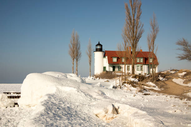 Alcona Michigan - USA, October 6, 2025. Sturgeon Point lighthouse, a painted white brick structure with red storm shutters. Sturgeon Point Lighthouse dates from 1870 protects the northeastern Michigan lake Huron coast.