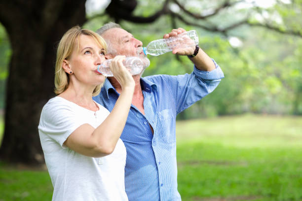 istock Portrait senior couple standing drinking water 924640888
