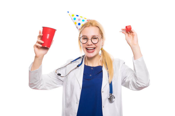 istock Woman doctor in white coat with party stuff 924645342