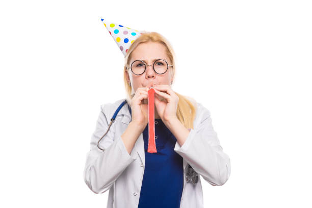 istock Woman doctor in white coat with party stuff 924645352