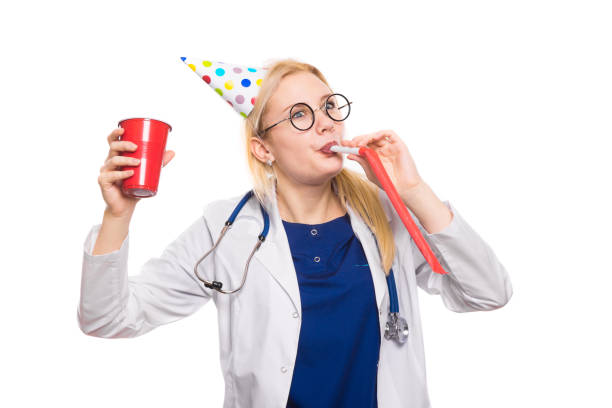 istock Woman doctor in white coat with party stuff 924645376